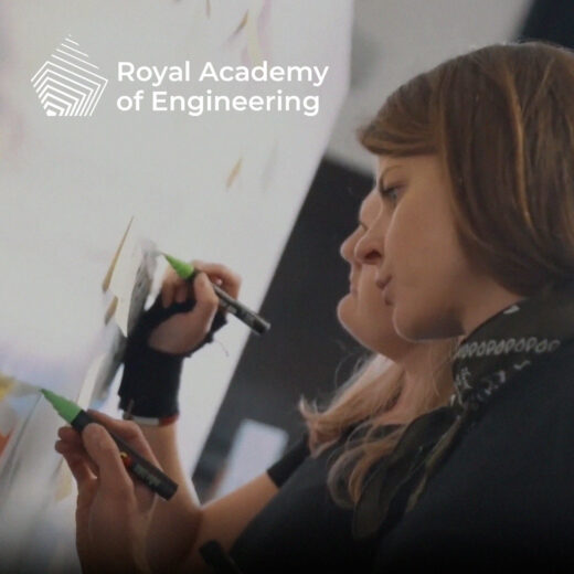 SmartUp Visuals scribers in action at the Royal Academy of Engineering’s annual meeting, skillfully capturing key discussions with dynamic illustrations on large boards as attendees engage in the event.