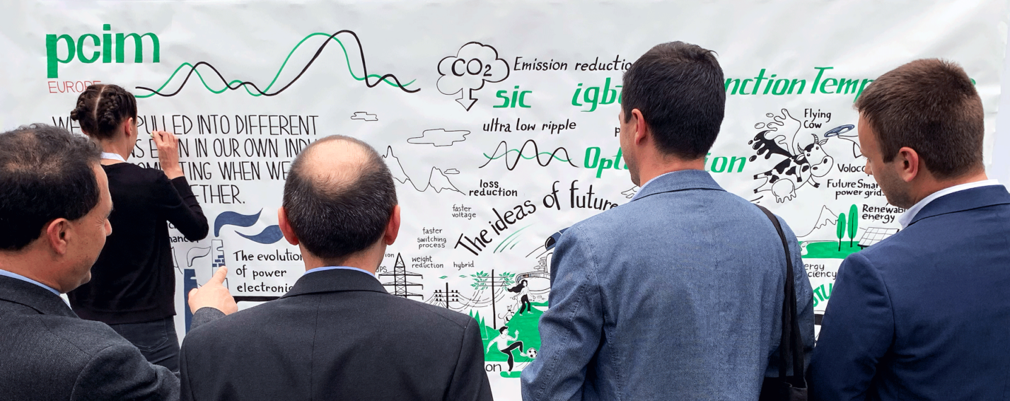 An audience gathers to watch a graphic recorder capture key ideas in real-time, turning discussions into engaging visual storytelling at an event