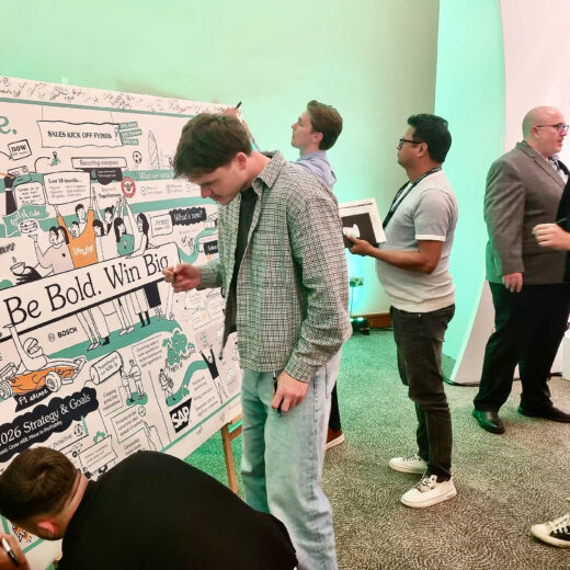 Attendees engaging with a live scribing visual summary at a strategy event.
